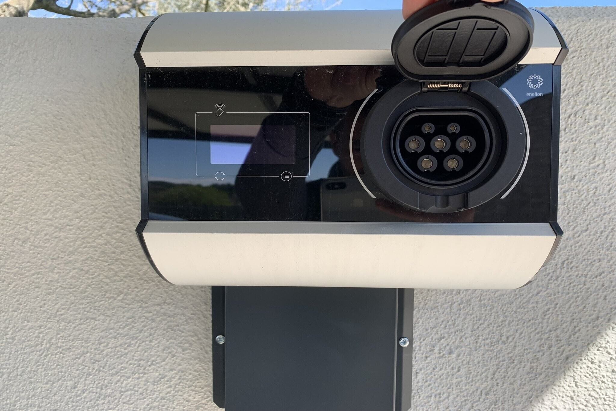 A security camera with a circular lens and a keypad, mounted on a wall.