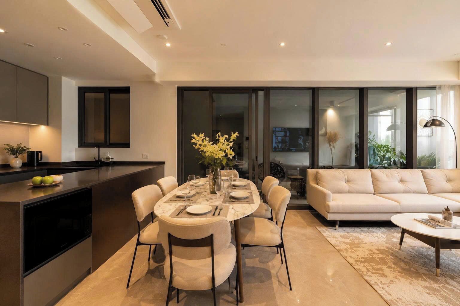 A modern living space with a dining area, kitchen, and seating area.
