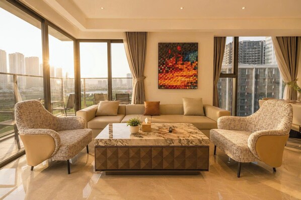 A modern living room with a sofa, two armchairs, a coffee table, and a large window with a city view. - The Opera Residence - Pool & Sauna (Ho Chi Minh City)