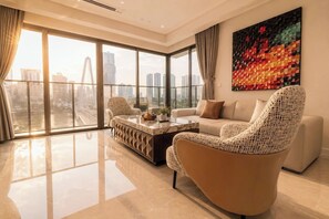 A modern living room with a large window, a sofa, a coffee table, and a chair. - The Opera Residence - Pool & Sauna (Ho Chi Minh City)