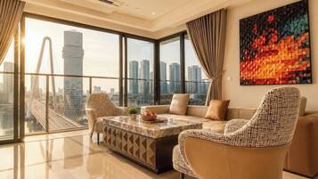 A modern living room with a large window, a sofa, a coffee table, and a city view.