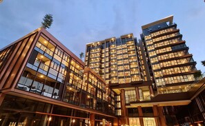 A modern hotel with multiple floors, large glass windows, and a well-lit entrance area. - The Galleria Thu Thiem - Panorama View (Ho Chi Minh City)