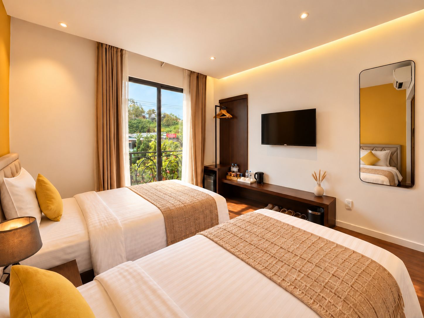 A hotel room with two beds, a TV, a balcony, and a minibar.