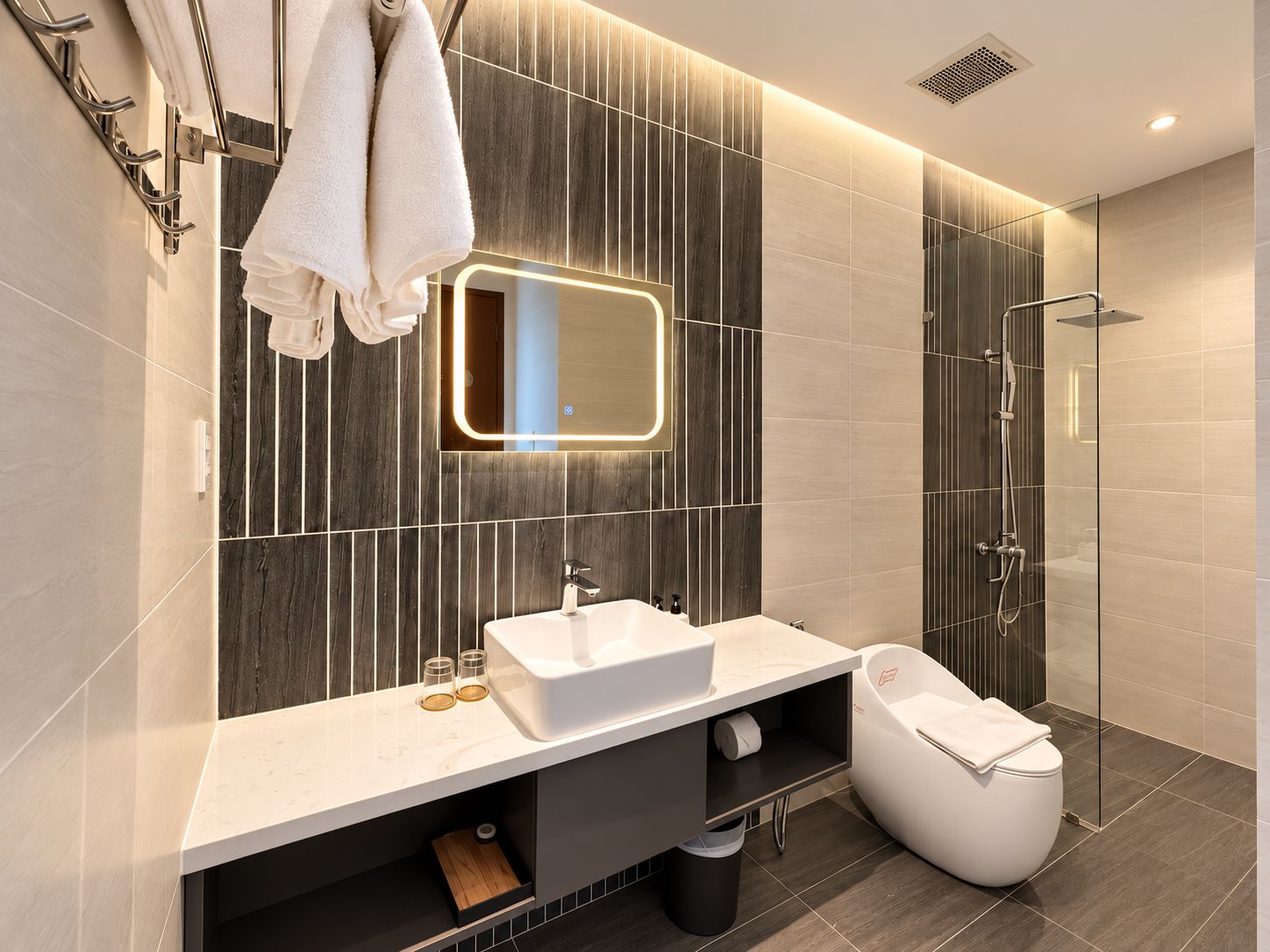 A modern bathroom with a vanity, a mirror, a shower, and a toilet.