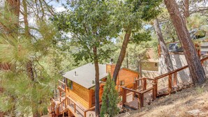 A wooden cabin with a deck and a staircase, surrounded by trees. - 1 Mi to Skiing: Mtn-view Cabin in Big Bear Lake (Big Bear Lake)