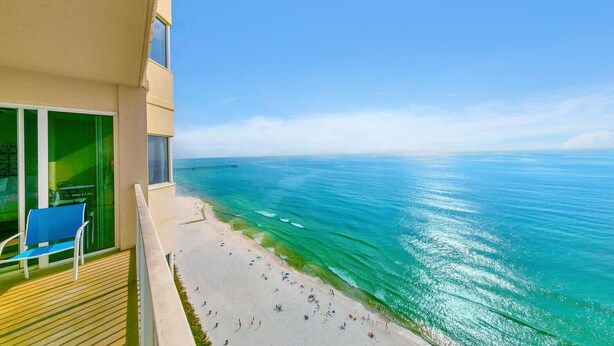 A balcony with a view of a beach and the ocean. - 🏖️Beach Front | Heated Pool | Hot Tub | Tidewater 1902☀️ (Panama City Beach)