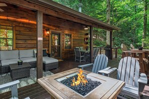 A wooden cabin with a fire pit, outdoor seating, and a deck overlooking a forest. - Paradise Found- Cherry Log GA (Cherry Log)