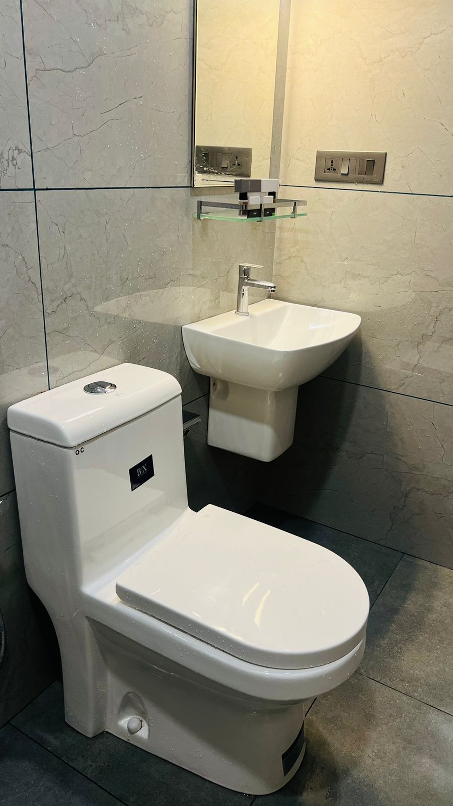 A modern bathroom with a toilet, bidet, and sink.