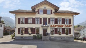 A two-story building with a sign reading "GASTHOF POST".