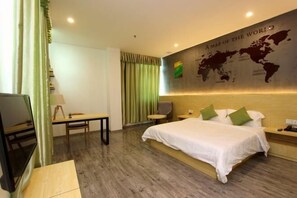 A hotel room with a large bed, a desk, a chair, a map of the world on the wall, and a view of the city. - Yi Mi Hotel Shenzhen Longgang Pinghu South China City (Shenzhen)