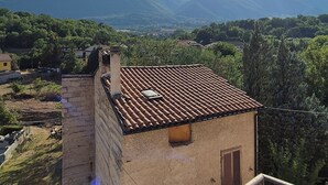 A balcony with a view of mountains and a clear sky.