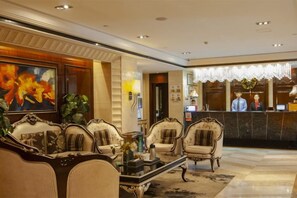 A lobby with ornate furniture, a reception desk, and a large floral painting. - Wuhan Meichen Yueshang Boutique Hotel (Wuhan)