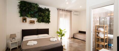 Deluxe Quadruple Room | Hypo-allergenic bedding, down duvets, memory-foam beds