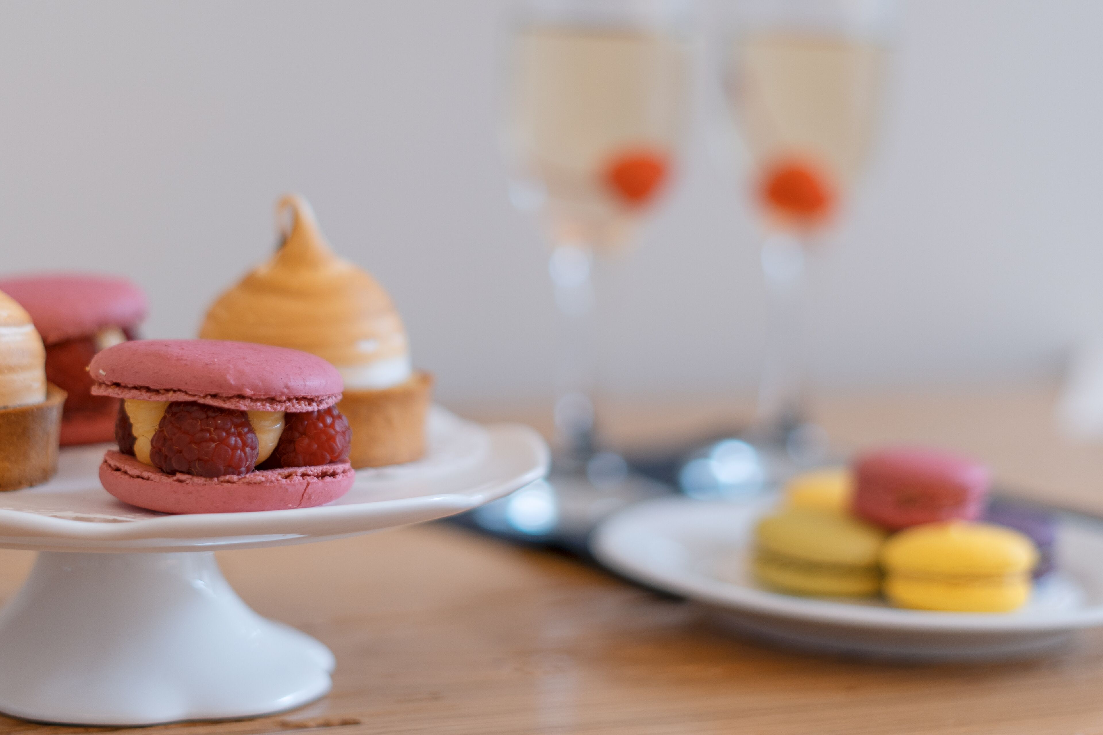 A dessert table with macarons and a cake.