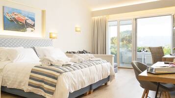 A hotel room with a bed, a desk, a chair, a window with a view, and a painting on the wall.