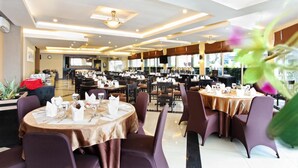 Un restaurante espacioso con numerosas mesas y sillas, dispuesto en una distribución moderna.