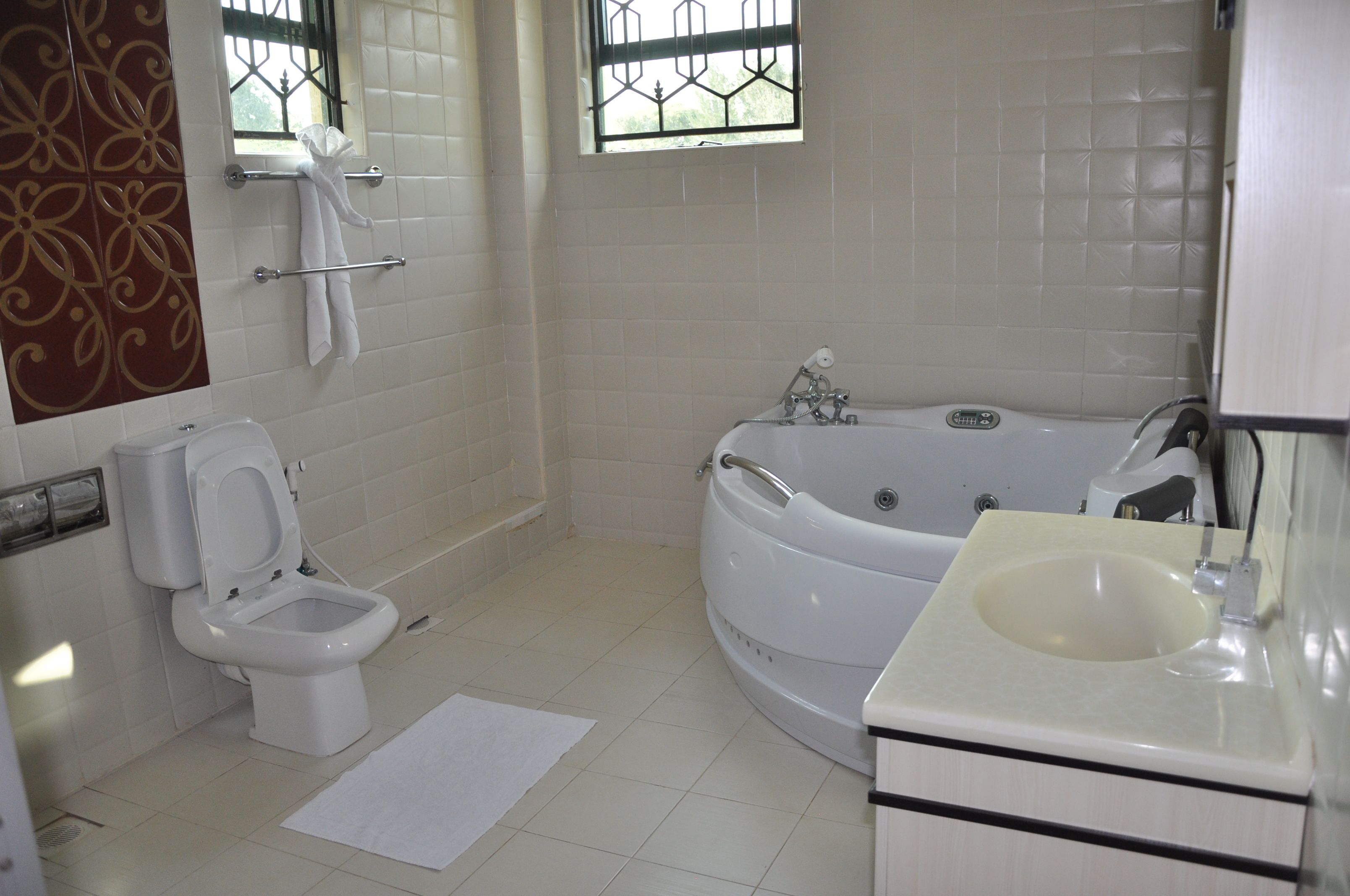 A bathroom with a toilet, bathtub, and sink.