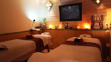 Relax in this serene spa room with two single beds, a flat-screen TV, and a calming ambiance.