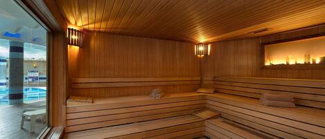 A sauna with wooden benches and a view of a city skyline through a glass wall.