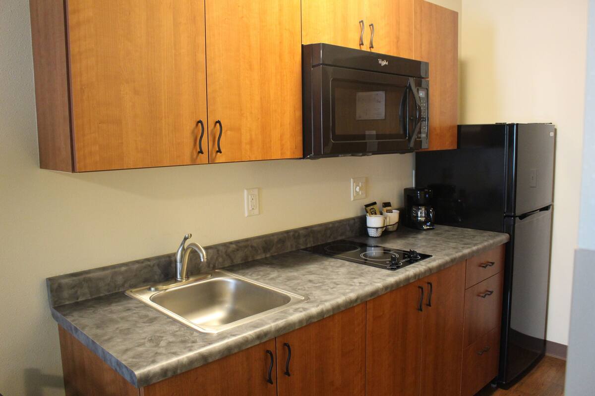 full-sized fridge, microwave, stovetop, coffee/tea maker