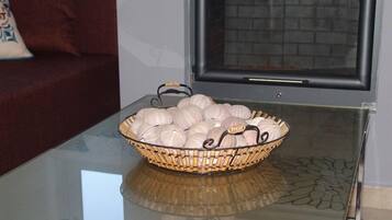 A glass-top table with a woven basket containing several round, textured objects.