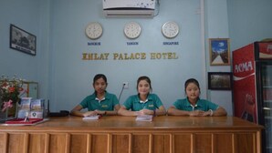 A reception desk at Inlay Palace Hotel with clocks indicating Bangkok, Yangon, and Singapore. - Inlay Palace Hotel (Nyaungshwe)