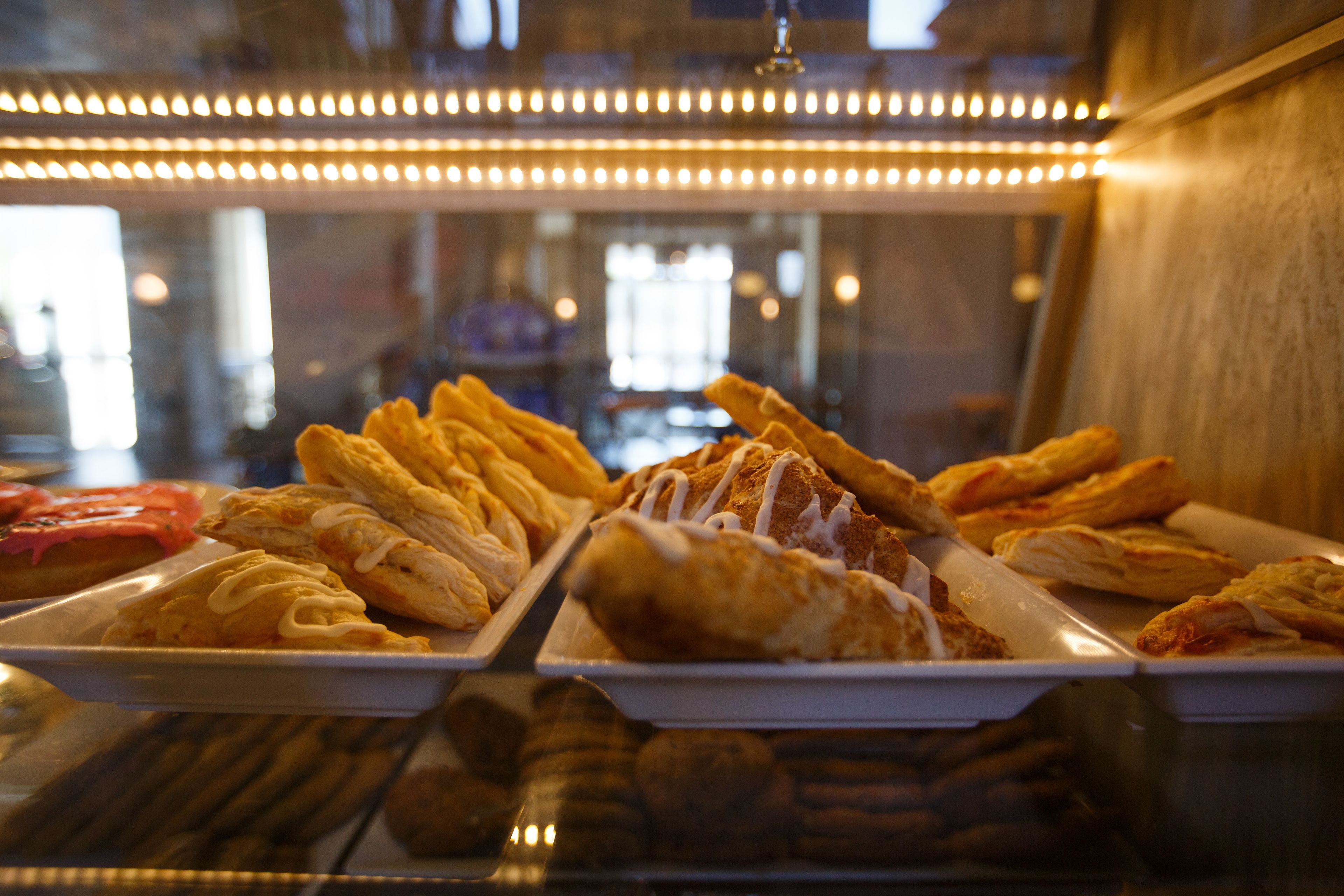 A display case with various pastries and baked goods.