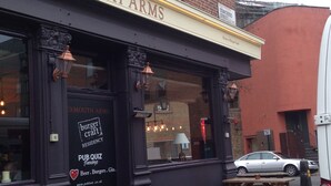 A pub named 'Exmouth Arms' with outdoor seating and a sign advertising a pub quiz. - Publove @ Exmouth Arms Euston (London)