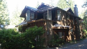 A large wooden house with a gabled roof, multiple windows, and a chimney. - Sea Star Beach Retreat (Tofino)