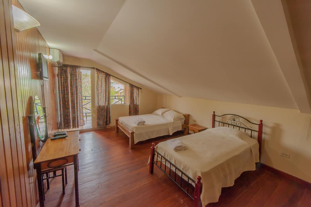 family twin room, multiple beds | balcony view