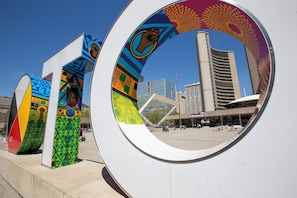 A modern building with a unique circular design element in the foreground. - Chestnut Residence - Campus Accommodation (Toronto)
