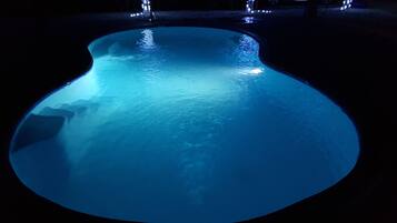 Swimmers can enjoy a large oval-shaped pool with a smooth surface.