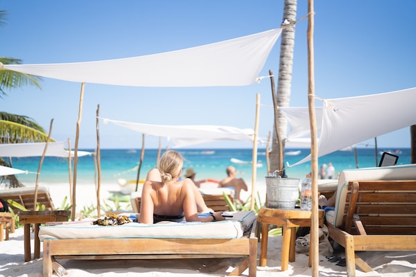 On the beach, white sand, sun-loungers, beach umbrellas