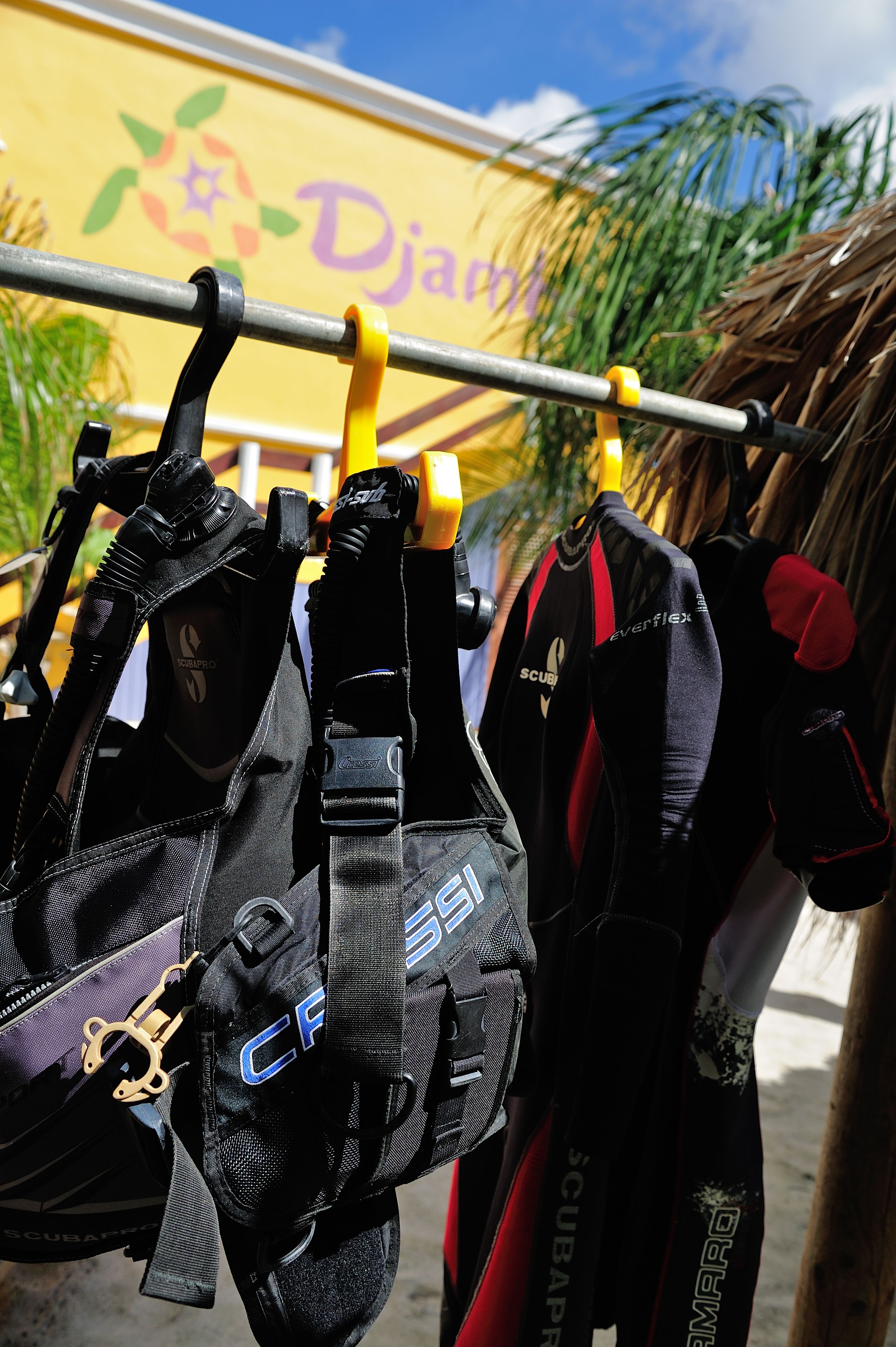 Scuba diving gear hanging on a rack.