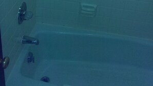 A bathroom with a bathtub, a shower, and a toilet. - Airport Lodge Wichita Kansas (Wichita)