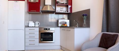 Fridge, microwave, coffee/tea maker, cookware/dishes/utensils