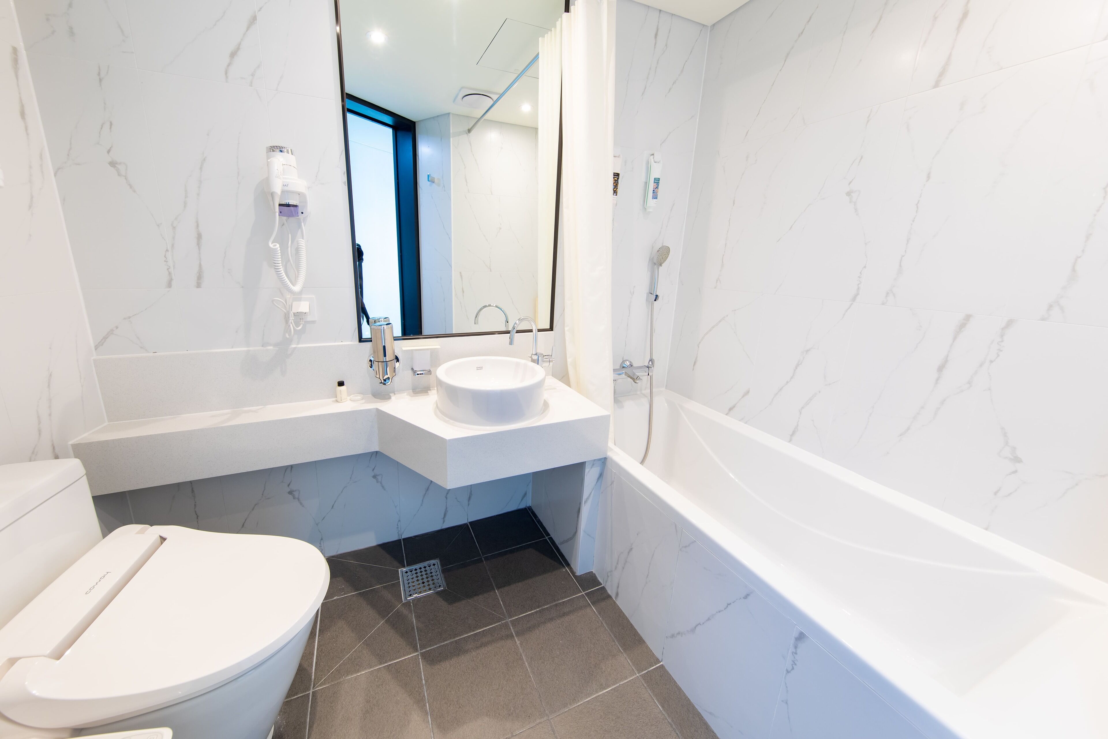 standard twin room | bathroom | shower, hair dryer, slippers, towels