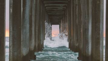 An underwater view of a pier with a clear path leading to the water's edge.