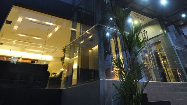 A modern building with a glass facade, a visible staircase, and a sign that reads "DREAMTEL." - DREAMTEL Jakarta (Jakarta)