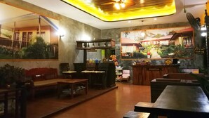 A cozy restaurant interior with a wooden ceiling, a bar area, and a seating section. - Paradise Bungalows (Ko Chang)