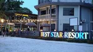 A resort with a sign reading "BEST STAR RESORT" and a "beach cove" sign.