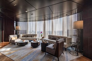 A modern living room with a sofa set, a coffee table, and a floor lamp. - NUO Hotel Beijing (Beijing)
