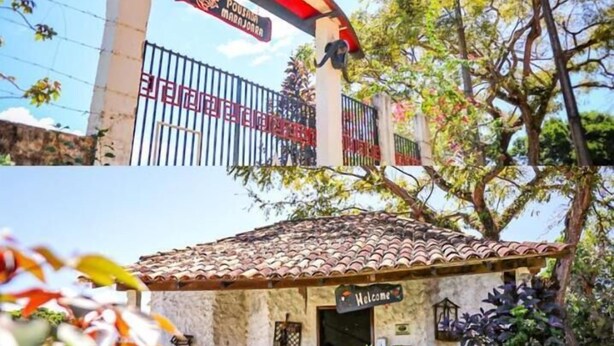A traditional building with a tiled roof, a 'Welcome' sign, and a decorative animal statue in the garden. - Pousada Marajoara (Soure)