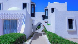 A white building with a curved pathway and small windows. - Aljazira Beach & Spa  -  Families and Couples Only (Mezraia)