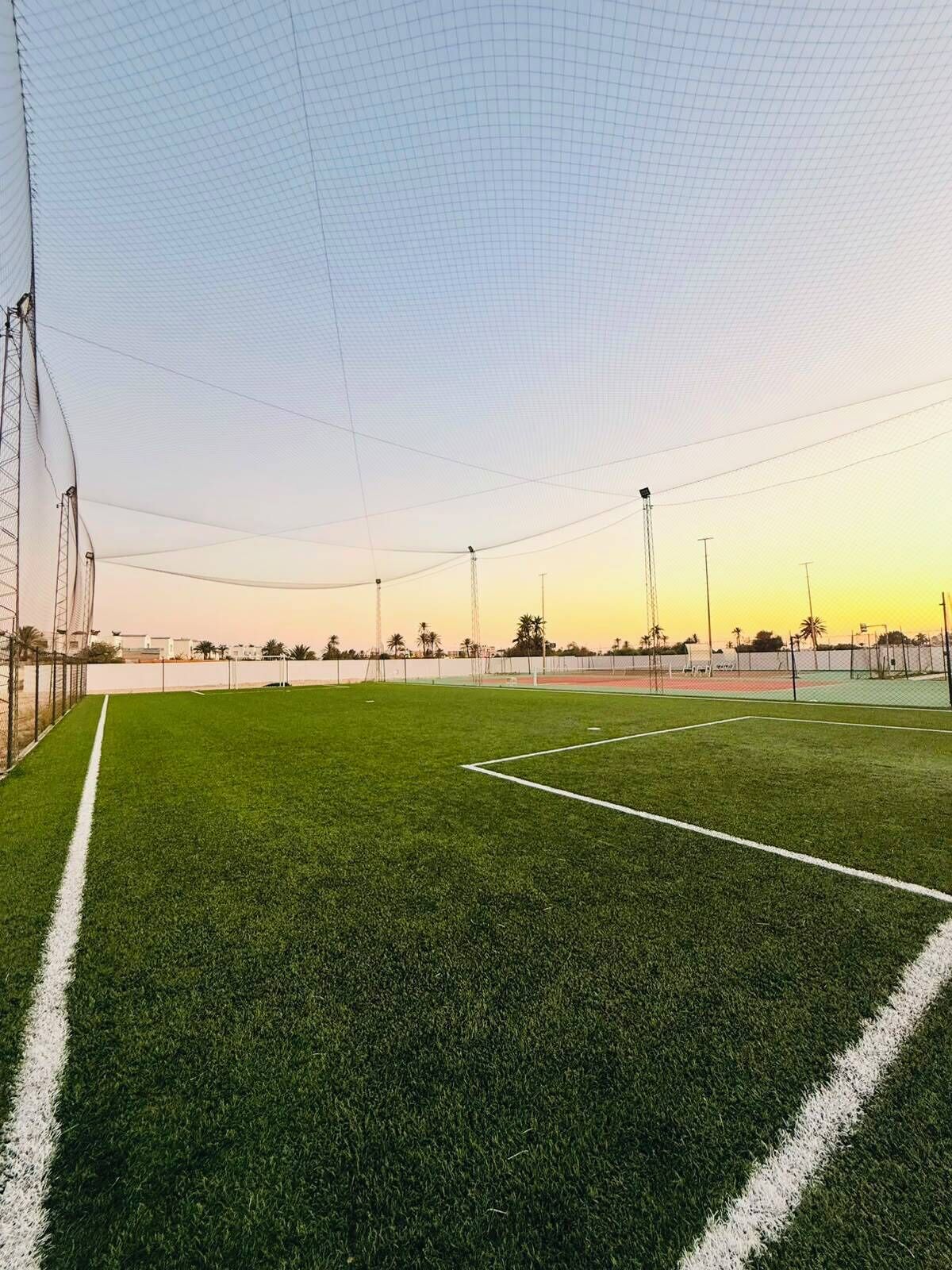 A sports field with goalposts and a net.