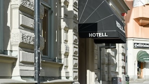 A hotel entrance with a sign reading "HOTEL Bemax" and a black awning. - Hotel Bema (Stockholm)