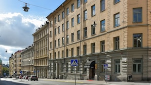 A multi-story hotel with a classic architectural style, featuring a prominent entrance and a pedestrian crossing sign. - Hotel Bema (Stockholm)