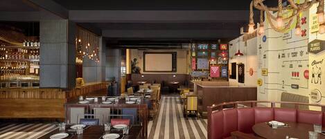 A restaurant with a bar area, booths, and a counter.