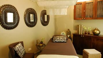 Relax in comfort with a long central bed and two chairs, perfect for unwinding.