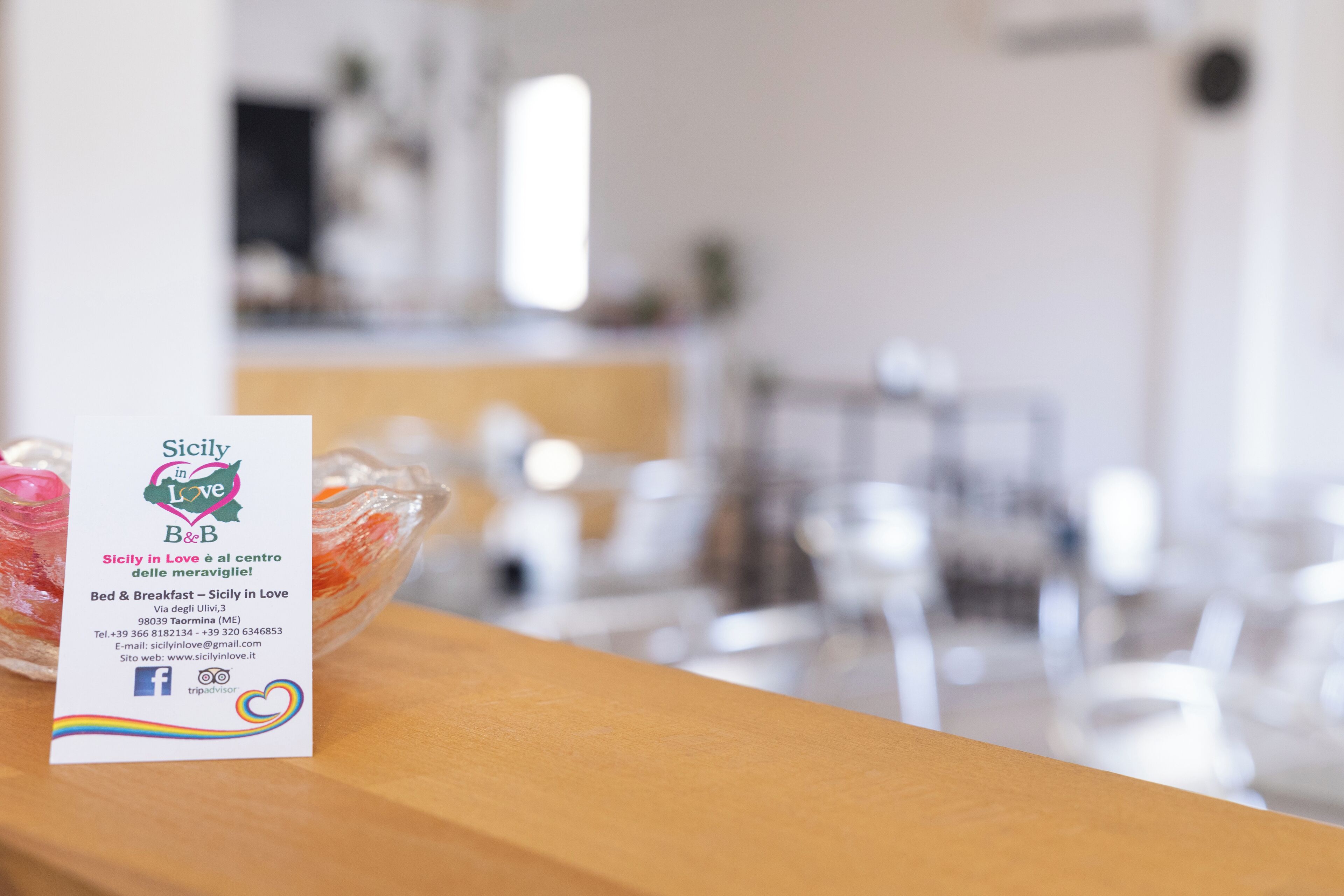 A business card for "Sicily in Love B&B" with contact information and a website URL.